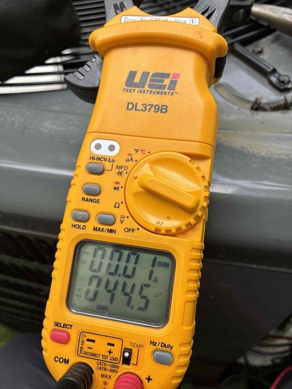 Completed routine HVAC cooling maintenance on residential air conditioning system. Inspected condenser coil assembly and found debris accumulation between fins; verified electrical components and system operation using digital multimeter to ensure proper voltage and performance parameters. Unit operational with all readings within manufacturer specifications.