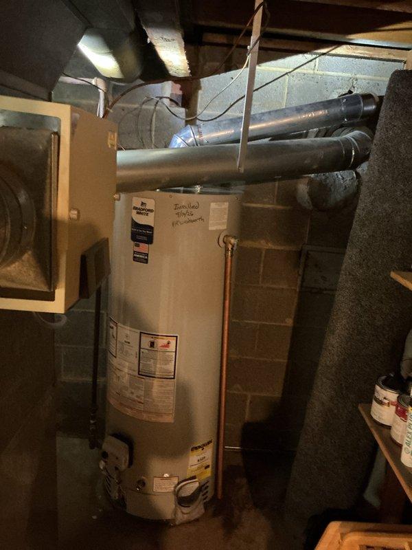 Responded to emergency service call for leaking tanked water heater in basement utility area. Upon inspection, identified active leak requiring immediate attention and documented existing unit condition including plumbing connections, copper piping, valve assemblies, and manufacturer specifications. Assessed water heater installation, surrounding HVAC ductwork clearances, and utility room configuration to determine appropriate repair or replacement options for the customer.