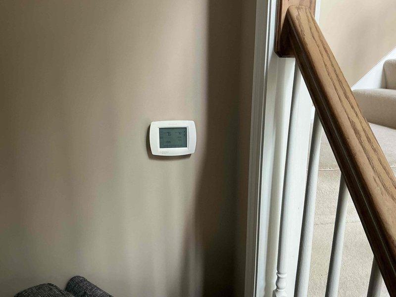 Conducted diagnostic evaluation and presented furnace replacement options to homeowner. Assessed existing HVAC system including thermostat operation and inspected utility area where furnace equipment is located, noting visible water staining on floor near plumbing connections that may require attention during installation.