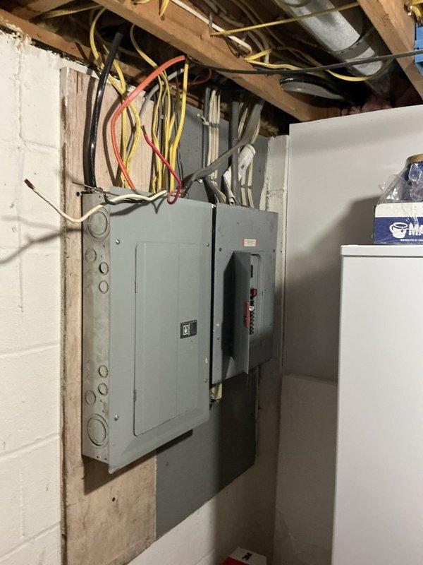 Conducted on-site electrical assessment for residential backup generator installation at property with no existing generator system. Evaluated current electrical service configuration, documenting existing main breaker panel and electrical infrastructure in unfinished basement utility area to determine optimal generator sizing, transfer switch placement, and integration requirements for whole-house or critical circuit backup power solution.