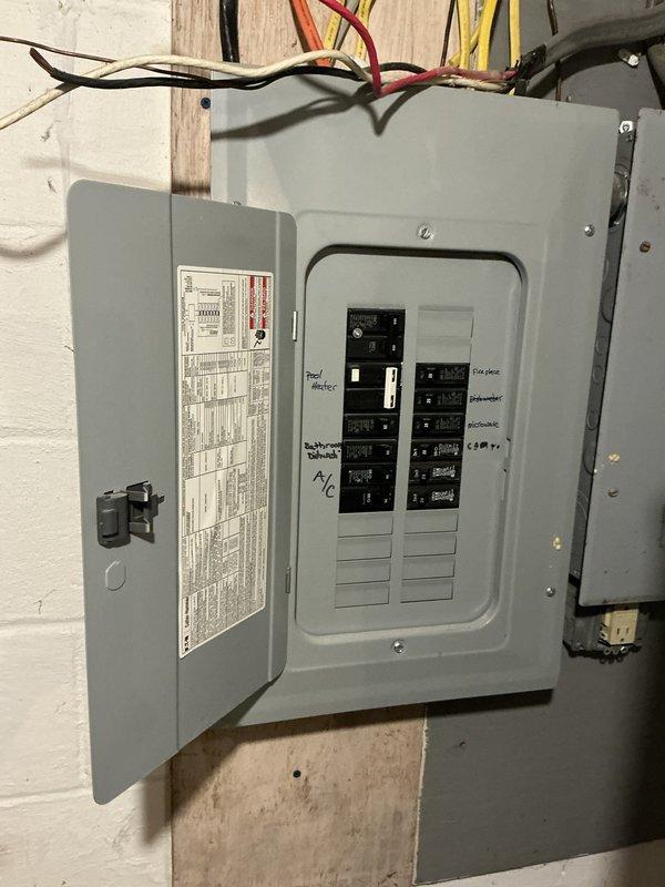 Conducted on-site electrical assessment for residential backup generator installation at property with no existing generator system. Evaluated current electrical service configuration, documenting existing main breaker panel and electrical infrastructure in unfinished basement utility area to determine optimal generator sizing, transfer switch placement, and integration requirements for whole-house or critical circuit backup power solution.