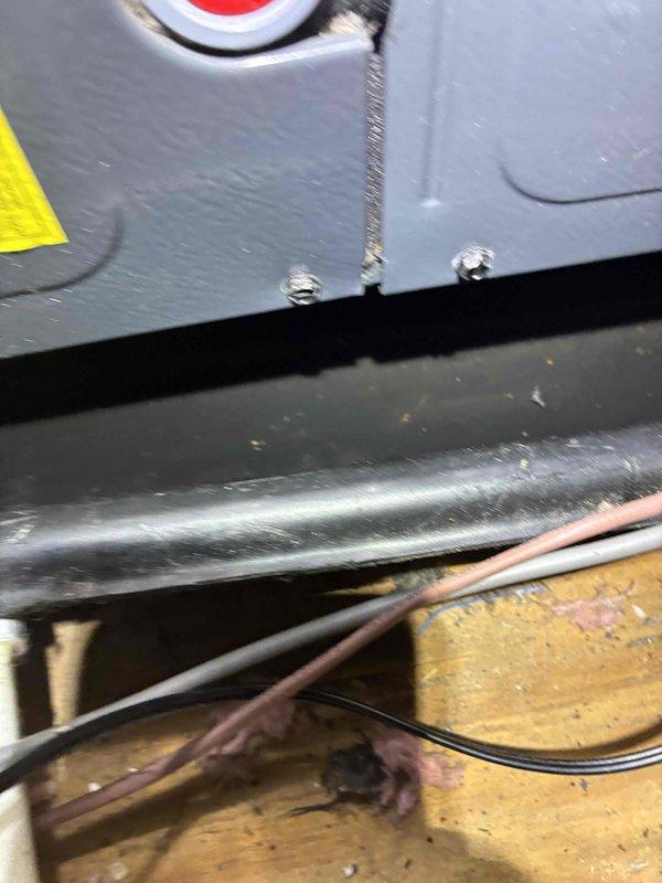 Responded to service call for air conditioning unit leaking from attic installation into second floor bedroom. Upon inspection, examined attic-mounted HVAC system and documented equipment condition, including condensate drainage components, insulated refrigerant lines, and electrical connections. Photographed affected areas showing mechanical equipment installation, wiring configuration, and insulation condition to assess potential leak sources and recommend appropriate repairs.
