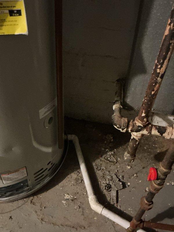 Responded to emergency plumbing call regarding water leak affecting Bradford White water heater (Model NG275N6) and suspected drain stack pipe failure. Upon inspection, identified leak originating from bathroom drain stack above water heater location, causing water to overflow into drain pan. Discovered improperly installed drain pan outlet preventing adequate drainage, resulting in pan overflow and damage to water heater heating element. Corrected drain pan installation to ensure proper drainage functionality and prevent future overflow conditions. Addressed corroded drain stack piping showing significant rust deterioration and replaced compromised sections with new materials. Verified all connections for proper sealing and tested drain system flow from affected bathrooms to confirm resolution of leak issue. Water heater drain pan now functioning as designed to protect unit from potential water damage.