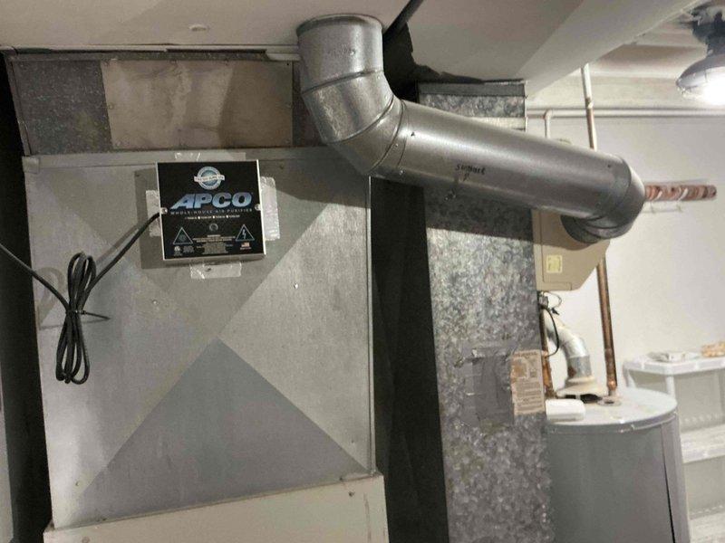 Completed estimate for full HVAC system replacement including 25-year-old air conditioning unit and furnace, both original equipment installed in 2001. Inspected existing basement furnace installation with air handler, ductwork, and APCO UV air purification system, as well as outdoor condensing unit. Documented current system configuration and provided replacement options for complete whole-house heating and cooling system upgrade.