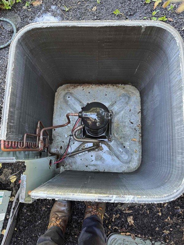 Completed comprehensive preventive maintenance on residential outdoor condensing unit equipped with protective mesh cage screening. Performed standard cooling season inspection including visual assessment of compressor, refrigerant lines with coiled section, and copper piping connections. Unit found in satisfactory operating condition with all components properly secured on concrete pad foundation.