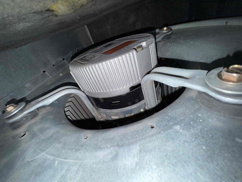 Responded to service call for 15-year-old furnace system requiring blower motor evaluation and repair. Upon inspection, assessed the existing blower motor assembly and mounting configuration within the air handler cabinet. Performed diagnostic evaluation to compare repair options and provided technical assessment of the motor condition, mounting hardware, and electrical connections. Documented equipment condition with detailed photography showing the cylindrical blower motor with manufacturer specifications, mounting bracket assembly, electrical conduit connections, and blower housing components with discharge venting system.