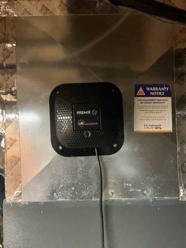 Returned to complete installation of replacement Premie air purification unit on air handler system. Successfully mounted new device to equipment panel and verified proper electrical connections and operational status upon completion.