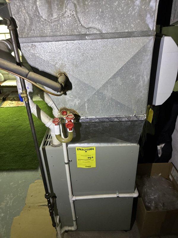 Conducted on-site evaluation of existing forced air HVAC system for residential replacement estimate. Assessed current furnace and air conditioning equipment located in basement utility area, documenting system configuration including ductwork, refrigerant lines, and utility connections. Discussed customer's specific cooling needs for primary downstairs living space, as upstairs area receives minimal use. Evaluated two potential replacement options: conventional central air conditioning system replacement to work with existing forced air infrastructure, and ductless mini-split system installation focused solely on downstairs zone. Photographed existing equipment installation and exterior condensing unit location to develop comprehensive replacement proposal addressing customer's zone-specific comfort requirements.