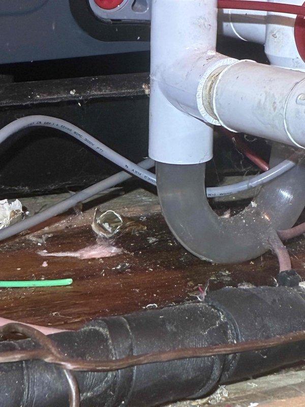 Responded to emergency water leak call in attic area where insurance adjuster and occupant reported large amounts of water originating from air handler unit. Upon arrival, accessed attic and inspected HVAC air handler system to identify source of water intrusion. Found evidence of significant moisture accumulation within air handler cabinet and surrounding areas, with water damage visible on wooden structural components beneath unit.

Conducted thorough inspection of air handler interior, examining condensate drain system, drain pan, and associated plumbing connections. Documented conditions showing accumulated debris and dust buildup within unit, oxidized copper refrigerant lines, and deteriorated insulation materials indicating prolonged moisture exposure. Inspected PVC condensate drain piping and discovered issues with drainage system contributing to water overflow.

Identified primary cause of water leak as condensate drainage system failure, resulting in water backing up into air 