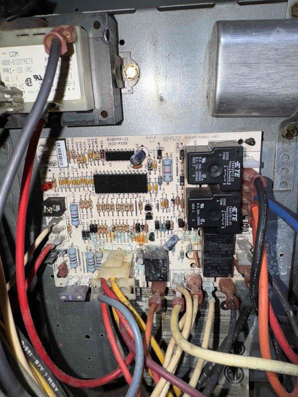 Responded to no-power furnace call resulting from previous basement flooding caused by hail storm damage. Gas company had previously shut off unit as a safety precaution. Conducted visual inspection of blower motor assembly and control board, documenting existing conditions with photos. Control board showed signs of age with visible discoloration and oxidation on circuit board surface, though electronic components including relays, resistors, and capacitors remained intact. Blower motor assembly and electrical connections appeared functional with no visible flood damage to these components. Appointment scheduled for follow-up service when family member can be present for complete system evaluation and restoration.