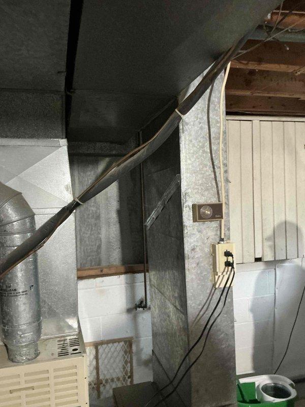 Conducted on-site evaluation for full HVAC system replacement in basement utility area with existing ductwork and infrastructure. Reviewed space constraints and measured existing 86K BTU equipment layout, documented 8x24 duct configuration and 30-inch clearance requirements. Provided comprehensive system options including humidifier integration and air filtration upgrades to meet customer specifications for complete heating and cooling system replacement.
