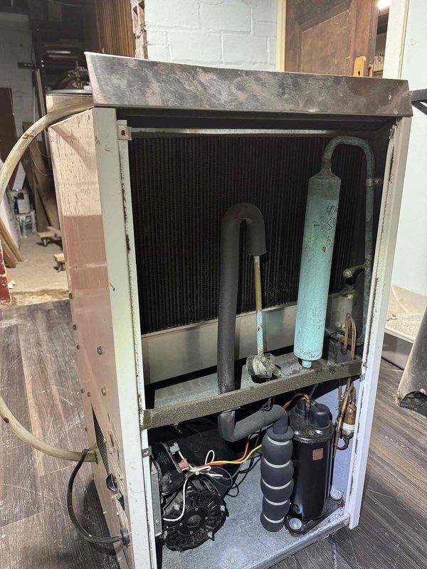 Responded to service call for non-operational dehumidifier system. Upon inspection, identified failed electrical relay component within the control circuit. Removed and examined the defective relay, which showed improper connection and wiring configuration affecting system operation. Accessed internal components of the unit, inspecting heat exchanger, compressor assembly, accumulator, and associated copper refrigerant lines for additional issues. Verified all mechanical components and electrical connections, documenting equipment condition for service records.
