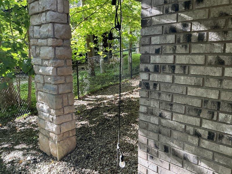 Conducted comprehensive site evaluation for generator installation at residential property. Assessed existing electrical infrastructure including current meter location, panel positioning, and available conduit pathways along exterior brick wall. Documented structural considerations for generator placement, evaluating clearance requirements under covered area with adequate ventilation through existing brick venting system. Examined grounding options and determined optimal routing for electrical connections from proposed generator location to main service panel. Photographed existing electrical equipment configuration and available installation space to develop accurate material list and labor requirements for permanent standby generator system installation.