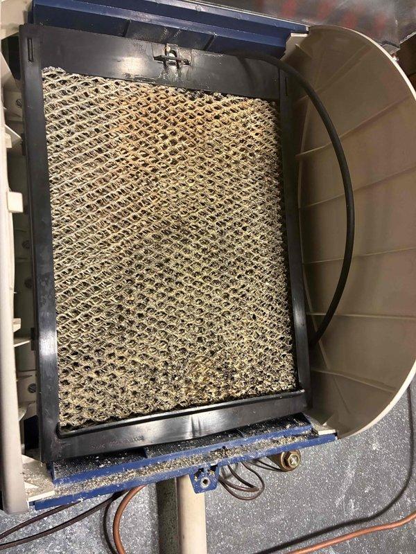 Completed routine heating system maintenance on aging HVAC unit with 10+ years of service. Inspected blower motor assembly, verified proper operation and electrical connections, and documented heavily soiled humidifier pad requiring replacement due to significant dust and debris accumulation that could restrict airflow and reduce system efficiency.