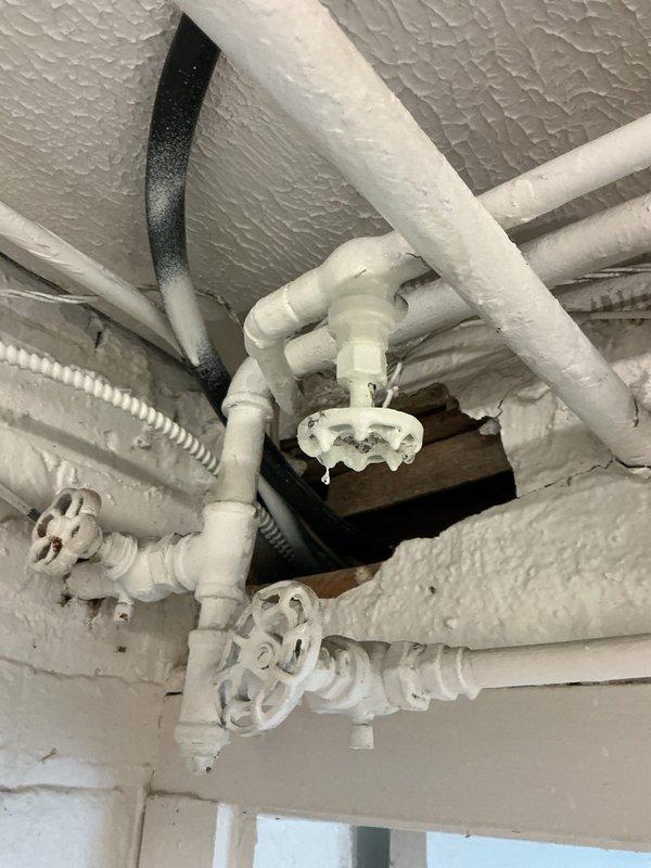 Responded to report of valve leaking in basement. Upon arrival, found extensive frost and ice buildup on plumbing infrastructure, indicating significant moisture exposure and freezing conditions affecting multiple pipes and valve assemblies. Inspected copper piping, PVC connections, and decorative shutoff valves in crawl space area with foam insulation. The frost accumulation on pipes, valve handles, and insulation material confirmed active leak combined with cold temperature conditions. Assessed brass fittings and connection points where copper transitions to PVC piping. Documented conditions showing ice crystallization on all exposed surfaces including pipe insulation wraps and valve components. Identified compromised areas requiring attention to prevent further water damage and potential pipe freezing issues.