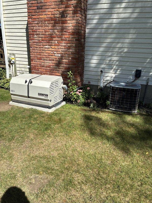 Completed residential HVAC assessment for air conditioning replacement options on a property with a 1992 AC unit and newer furnace. Documented existing outdoor condenser unit with cylindrical mesh cage design, evaluated system age and condition, and photographed current equipment configuration including generator and utility connections for replacement proposal development.