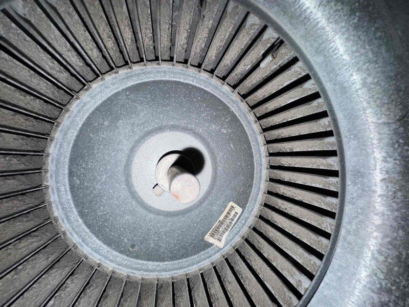 Completed scheduled heating maintenance visit on residential furnace system. Performed comprehensive inspection of blower assembly, documenting condition of squirrel cage blower wheel which showed moderate dust accumulation on blades and housing. Verified ambient temperature readings at 65.2°F using calibrated digital thermometer. Inspected blower motor shaft assembly and central hub components for proper operation. System operational and functioning within normal parameters upon completion of maintenance procedures.