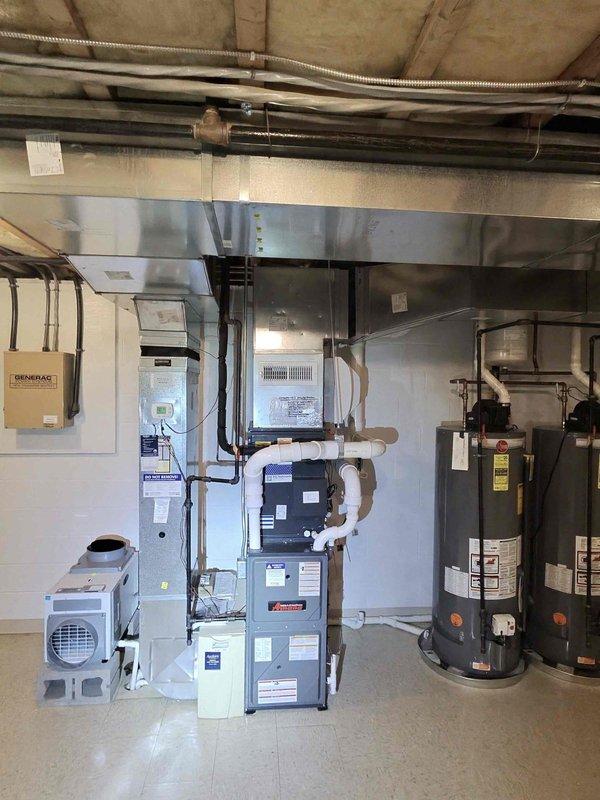 Responded to indoor air quality concern regarding inconsistent humidity readings throughout the home. Customer reported basement dehumidifier displaying 45% relative humidity while unit setpoint was 40%, with readings of 55% observed in other areas of the basement and upstairs levels. Performed system inspection of basement mechanical room equipment including furnace, dehumidification unit, and associated ductwork. Documented equipment installation and operating conditions with photographs for service records.