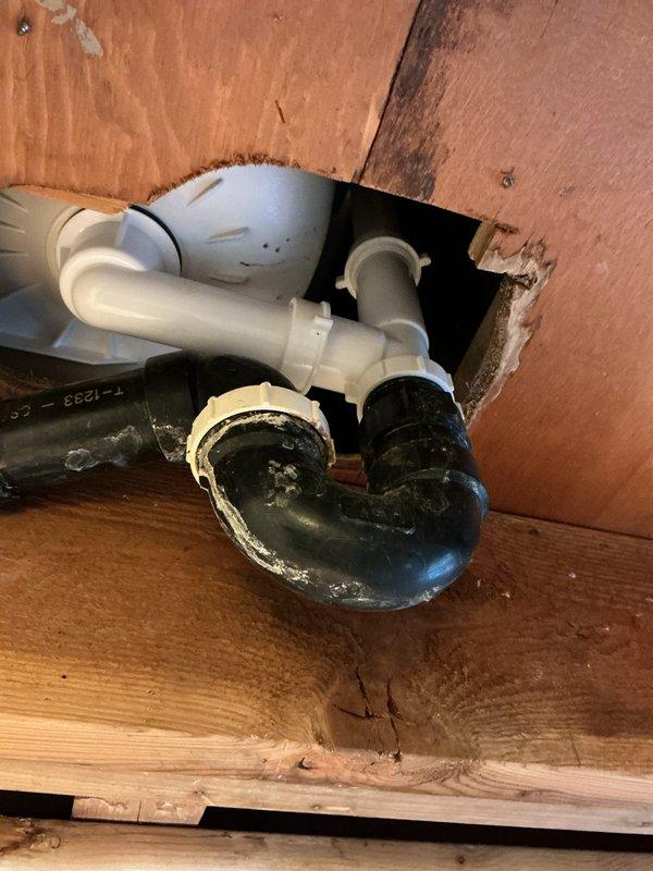 Replaced bathtub drain and overflow assembly with new chrome-finished components. Removed old deteriorated drain waste piping beneath fixture and installed new PVC drain assembly to ensure proper drainage and prevent future leaks.