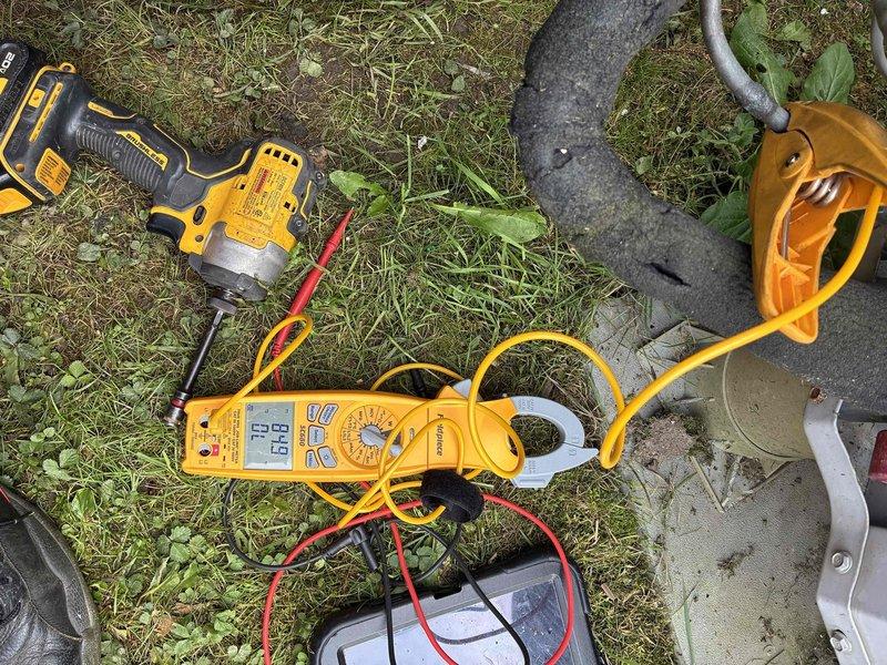 Completed comprehensive HVAC cooling system tune-up on outdoor condensing unit. Performed detailed inspection of electrical components, including capacitor assessment which showed significant rust and corrosion on housing and terminals. Utilized digital multimeter with clamp meter to verify electrical readings and system performance parameters. All connections tested and system operational upon completion.