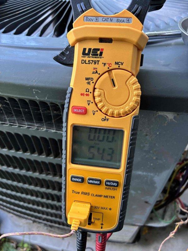 # HVAC Cooling Maintenance Completed

Performed comprehensive preventive maintenance on residential cooling system as part of ongoing service agreement. Conducted thorough inspection of outdoor condensing unit, including examination of evaporator coil assembly which showed accumulation of environmental debris including leaves, twigs, and organic matter across multiple fin sections. Utilized UEi DL579T True RMS clamp meter to verify electrical readings and system performance parameters, with temperature measurements indicating 54.5°F. Observed visible dirt accumulation and discoloration on coil fins, particularly in upper sections, along with cobweb material present on frame components. Documented current system condition through photographic evidence showing four-row coil configuration with varying degrees of soiling on metallic fins. Unit operational at time of inspection with no immediate mechanical failures noted, though cleaning recommended to optimize heat transfer efficiency and 