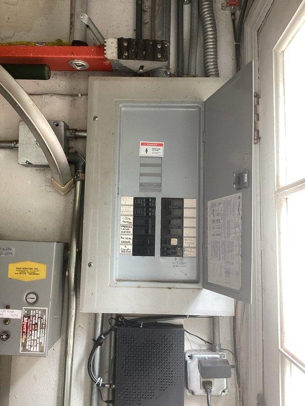 Completed site assessment and electrical evaluation for backup generator installation. Documented existing electrical infrastructure including main service panel with dual rows of circuit breakers, transfer switch location, and current electrical service capacity. Inspected gas meter and utility connections to verify adequate fuel supply specifications for generator requirements. Photographed electrical panel configuration, available mounting locations, and existing utility meter setup to develop comprehensive installation proposal for automatic standby generator system.