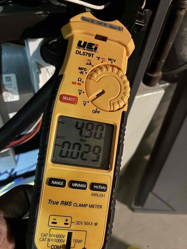 Completed heating tune-up service on two furnaces. Performed standard maintenance procedures including inspection of internal ductwork and heat exchanger components, noting normal dust accumulation consistent with operational systems. Verified electrical performance with clamp meter readings showing 49.8 amps and 60.29 Hz frequency, confirming proper power supply and system operation within manufacturer specifications. Both heating units tested and operating normally.