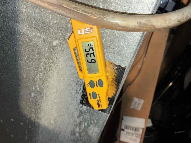 Completed comprehensive cooling system maintenance inspection as part of recurring preventive maintenance program. Performed electrical diagnostics using clamp meter to verify proper amperage draw and voltage levels at the condensing unit, recording readings of 40.10A and 24.77V to ensure system operating within manufacturer specifications. Conducted temperature differential measurements at the water heater and associated mechanical components, documenting 67.9°F reading to assess overall system performance and efficiency.