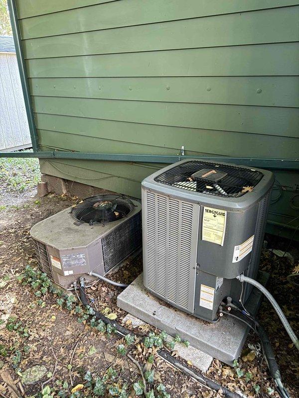 Responded to service call for two non-operational AC units at duplex property. First unit presented with humming noise but no cooling operation; diagnosed failed compressor capacitor and replaced with appropriate rated component, restoring normal function. Second unit at adjacent duplex showed no power; identified tripped breaker at electrical panel, reset breaker, and verified proper startup sequence and cooling operation. Cleared debris from both condenser units and confirmed adequate airflow through coils.