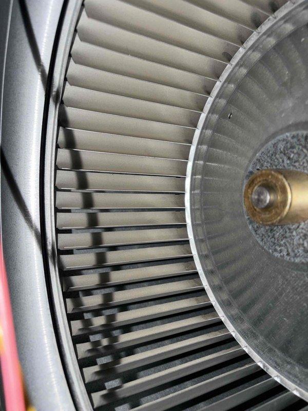 Completed comprehensive heating system maintenance inspection. Examined and documented blower assembly components, including squirrel cage fan wheel with radial blade configuration and central hub bearing assembly, confirming proper mechanical condition with minor dust accumulation present. Inspected UV light air purification system, verifying operational status and proper blue light emission for continued indoor air quality treatment.