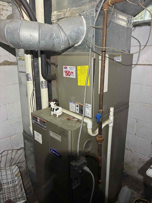 Completed comprehensive cooling system tune-up on residential Carrier HVAC system. Performed standard maintenance procedures including inspection of furnace and air handler units, verification of refrigerant line connections, examination of condensate drain system, and assessment of electrical components. Notable finding: motor terminal block exhibits significant dirt accumulation, corrosion, and debris requiring attention during future service to prevent potential electrical issues.