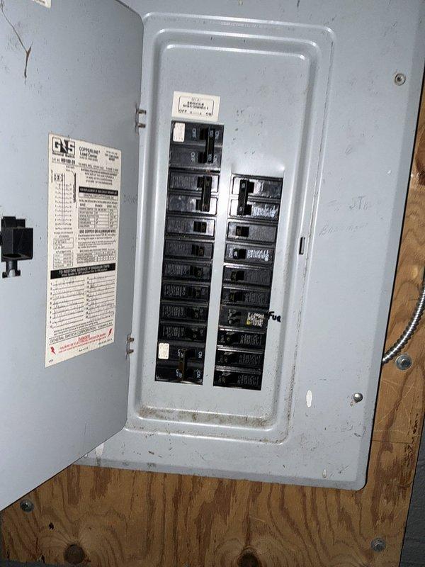 Conducted residential site evaluation for air conditioning system replacement. Assessed existing aging condenser unit showing significant weathering and debris accumulation, documented current electrical service panel configuration, and reviewed installation requirements for upgraded HVAC equipment to provide customer with replacement options.
