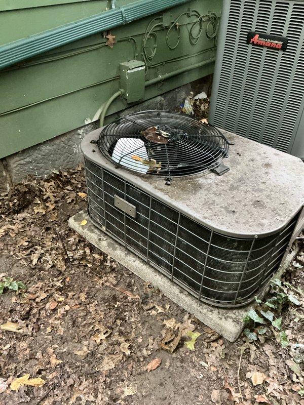 Conducted residential site evaluation for air conditioning system replacement. Assessed existing aging condenser unit showing significant weathering and debris accumulation, documented current electrical service panel configuration, and reviewed installation requirements for upgraded HVAC equipment to provide customer with replacement options.