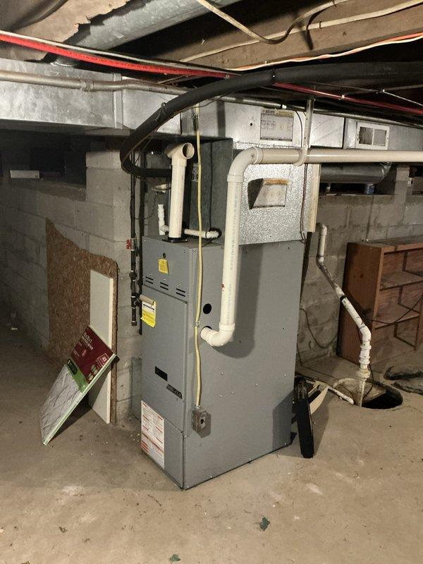 Conducted comprehensive HVAC system evaluation for aging equipment replacement estimate. Assessed existing gray furnace unit in basement mechanical room, documenting current condition including manufacturer specifications, PVC venting configuration, and ductwork connections. Inspected outdoor condensing unit, noting significant dirt and debris accumulation on fan assembly and housing, indicating extended service life without maintenance. Evaluated complete heating and cooling system infrastructure including supply and return ductwork, electrical connections, and gas piping. Photographed all equipment for proposal documentation. Discussed water heater inspection requirements with customer as part of overall mechanical system assessment. Prepared detailed replacement recommendations for complete HVAC system upgrade.