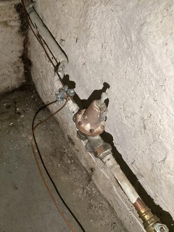 Completed courtesy plumbing inspection of basement utility area. Documented existing hydronic heating system including expansion tank, copper piping distribution network, boiler unit, and heat exchanger components, with all equipment appearing properly connected and functional at time of inspection.