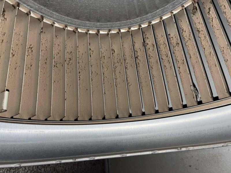 Completed comprehensive heating system tune-up and inspection. Performed thorough assessment of heat exchanger, which showed significant dust and debris accumulation on the radial fin assembly requiring attention for optimal heat transfer efficiency. Verified system operation with temperature readings at 142.1°F, confirming proper heating function within normal operating parameters.