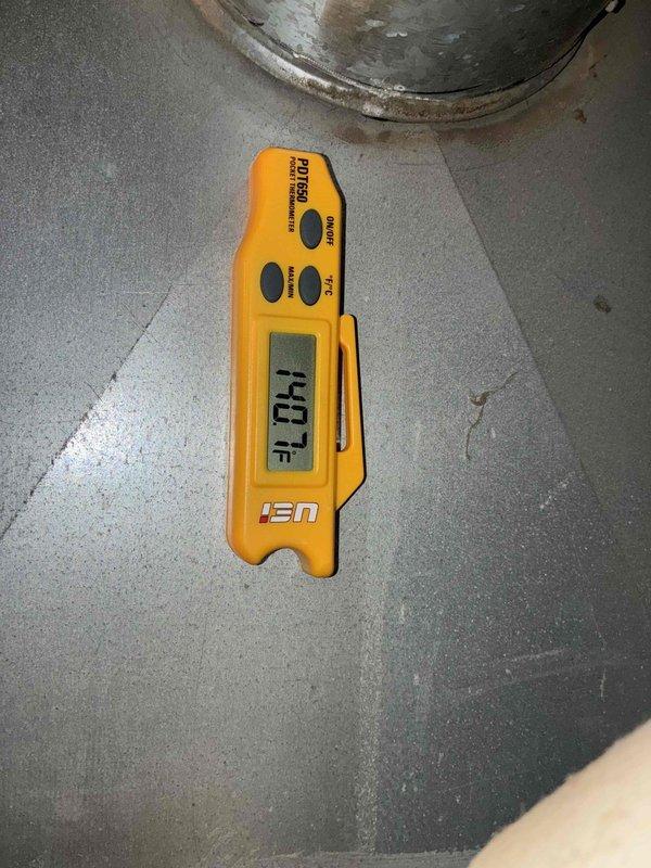 Completed comprehensive heating system tune-up and inspection. Performed thorough assessment of heat exchanger, which showed significant dust and debris accumulation on the radial fin assembly requiring attention for optimal heat transfer efficiency. Verified system operation with temperature readings at 142.1°F, confirming proper heating function within normal operating parameters.