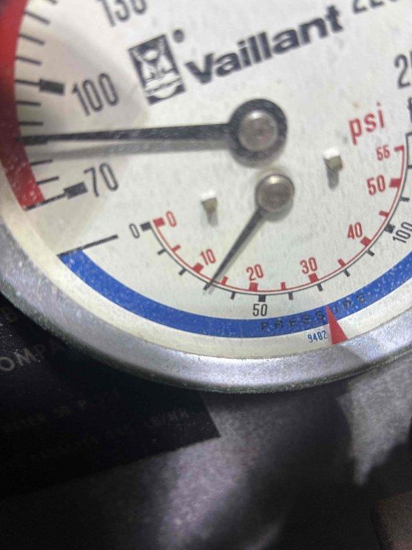 Completed scheduled preventive maintenance on Vaillant water boiler system. Inspected and photographed pressure gauge showing operational readings within normal parameters, and examined internal vessel condition noting minor mineral deposits and condensation present on interior walls. All components found functioning properly with system maintaining adequate pressure levels for continued operation.