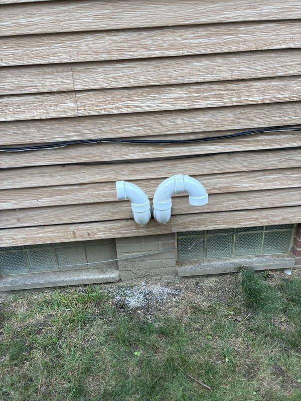 Responded to failed inspection for HVAC installation. Documented abandoned inlet openings and PVC vent pipe terminations extending through exterior siding that require correction to meet code requirements. Photographed exterior vent configuration and interior attic space showing connector and insulation conditions for compliance verification and correction planning.
