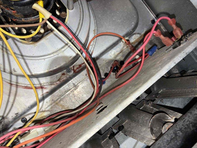 Responded to no-heat call for furnace diagnostic. Upon inspection, found control board showing signs of moisture damage and corrosion on circuit board surface and surrounding cabinet area. Evaluated electrical connections, wiring harness, and blower assembly. Documented existing conditions with photos showing compromised control board and interior components requiring attention.