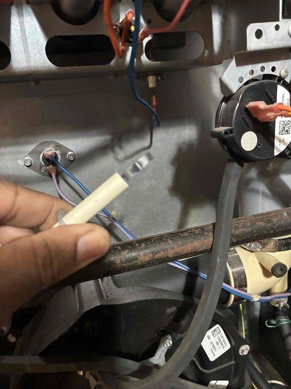 Performed pre-season heating maintenance on 16-year-old Amana furnace with history of condensation leakage from air conditioning system onto heating components. Conducted thorough inspection of electrical connections, replacing deteriorated wire connectors and securing loose wiring throughout the unit. Examined heat exchanger panels for corrosion and structural integrity, noting surface oxidation on metallic piping consistent with age and normal heat cycling. Inspected pressure switch, safety controls, and associated wiring harnesses for proper operation. Verified condensate drain system functionality to prevent future water intrusion issues that previously affected the furnace. All electrical connections were properly terminated and secured, and unit was tested for safe operation prior to heating season.