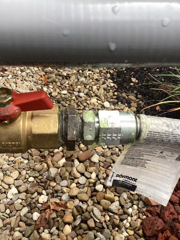 Responded to report of gas odor detected by technician and inspector during generator installation meeting. Conducted thorough inspection of exterior gas line connections and associated plumbing components, including brass shut-off valve with quarter-turn handle and flexible braided stainless steel supply line positioned near building foundation. Documented existing installations with photographic evidence for further evaluation and recommended follow-up gas leak detection service to ensure system safety and code compliance.