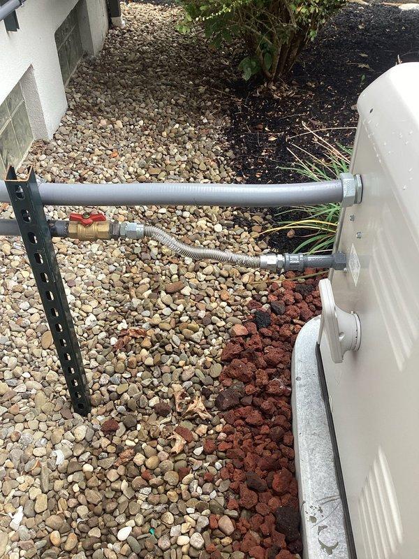 Responded to report of gas odor detected by technician and inspector during generator installation meeting. Conducted thorough inspection of exterior gas line connections and associated plumbing components, including brass shut-off valve with quarter-turn handle and flexible braided stainless steel supply line positioned near building foundation. Documented existing installations with photographic evidence for further evaluation and recommended follow-up gas leak detection service to ensure system safety and code compliance.