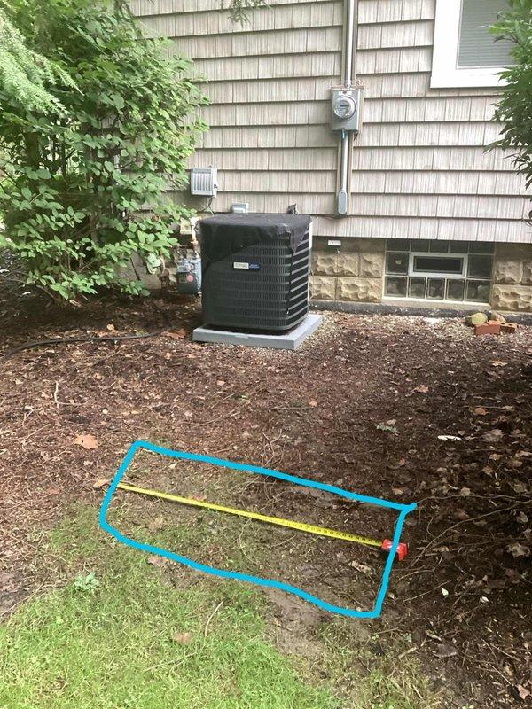 Conducted comprehensive electrical assessment for residential generator installation at single-family home with existing HVAC infrastructure. Evaluated current electrical service capacity, meter location, and optimal routing path for generator supply conduit along exterior wall with tan wood shingle siding. Documented site conditions including existing AC unit placement on concrete pad, available space in mulched landscaping bed for generator positioning, and measured distances for electrical run from main service panel to proposed generator location, ensuring compliance with NEC clearance requirements from structure and HVAC equipment.