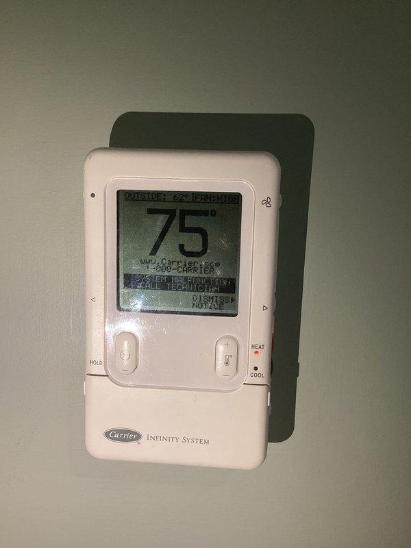 Responded to service call for air conditioning system not operating. Upon arrival, inspected exterior AC disconnect box mounted on building exterior and verified proper labeling and conduit connections. Investigated reported short circuit condition in electrical panel affecting AC operation. Performed diagnostic testing and visual inspection of electrical components. Verified Carrier Infinity System thermostat displaying proper temperature readings and communication with HVAC system. Restored power to AC unit through disconnect switch, confirming system returned to normal operation with thermostat registering 75° indoor temperature.
