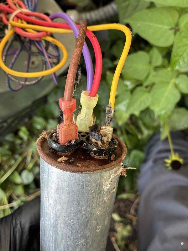 Responded to service call regarding high electric bills and potential AC system issues. Performed diagnostic inspection on both air conditioning units. Discovered failed capacitor on one unit exhibiting severe corrosion, burnt terminal connections, and electrical degradation from weather exposure. Tested electrical components with multimeter to verify capacitor failure and confirm system voltages. Identified the deteriorated capacitor as primary cause of system inefficiency, which would result in increased electrical consumption and reduced cooling performance. Recommended immediate capacitor replacement to restore proper system operation and reduce energy costs.