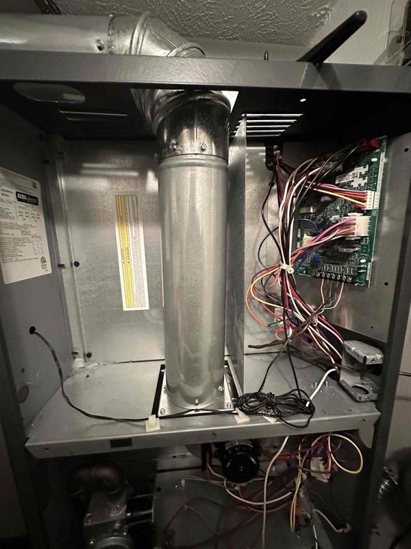 Completed comprehensive heating maintenance inspection on furnace system as part of ongoing preventive maintenance program. Performed temperature sensor testing and verification using calibrated probe on heat exchanger surface to ensure proper system operation and safety parameters. Conducted thorough inspection of blower motor assembly, air handler cabinet, and all internal components. Verified electrical control board connections, examined wiring harness integrity, and confirmed all terminal connections were secure. Documented equipment condition through detailed photography of critical components including temperature measurement points and electrical systems for maintenance records.