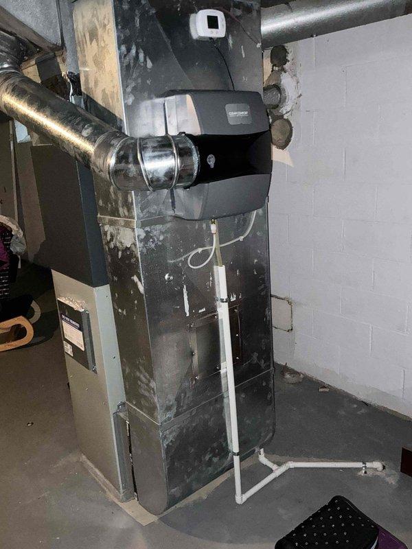 Conducted on-site assessment for furnace replacement. Evaluated existing aging furnace system showing visible wear, dust accumulation, and surface corrosion on associated piping. Documented current equipment configuration including ductwork connections, PVC condensate drainage system, and installation layout in basement mechanical room. Provided homeowner with replacement options and recommendations based on equipment condition and system requirements.