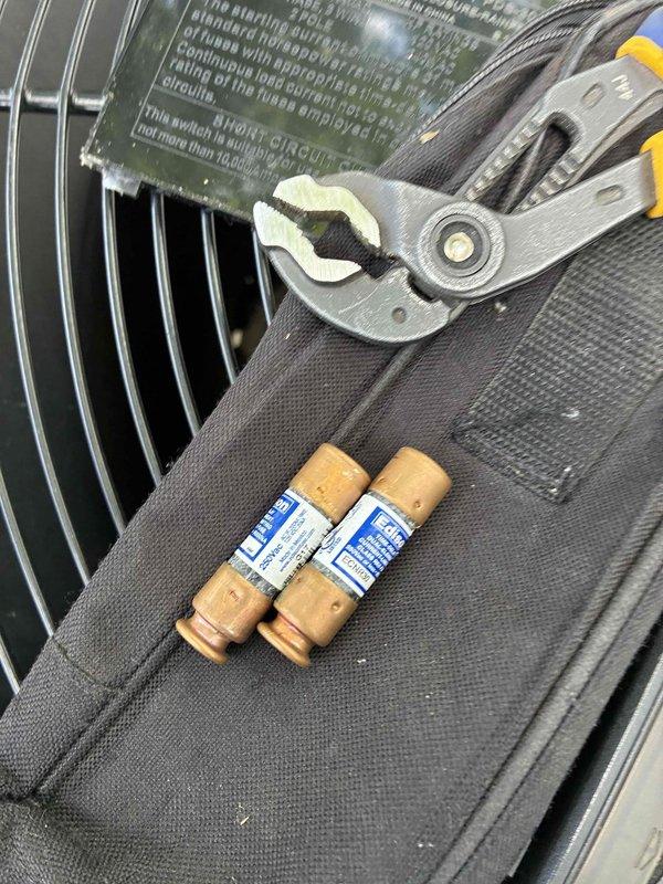 Responded to no cooling call where outdoor condenser unit was not operating. Upon inspection, found blown fuses in the outdoor unit's electrical panel. Replaced defective fuses and verified proper capacitor operation and all electrical connections. System tested successfully with condenser fan motor and compressor operating normally, restoring full cooling function to the unit.