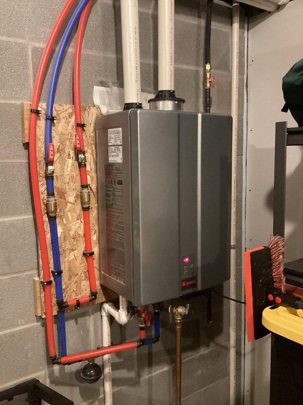 Completed routine plumbing maintenance visit focusing on tankless water heater system inspection. Inspected Rinnai tankless water heater unit, verified proper operation of all connections including PEX supply lines, brass fittings, valves, and gas line connections. Examined and cleaned filter trap component, removing accumulated lint and debris to maintain optimal system performance and water flow efficiency.